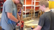 Students assembling robotic musical instruments