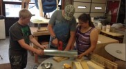 Students assembling robotic musical instruments